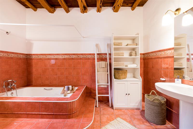 Bathroom with a tiled bathtub