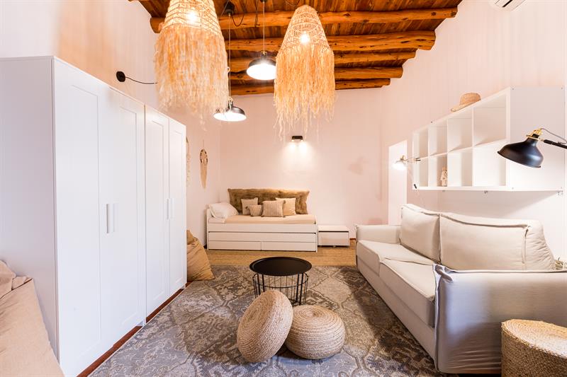 Large family bedroom with day beds, a sofa bed and woven pendant lights