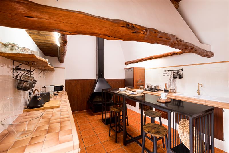 Kitchen with beamed ceiling and fireplace