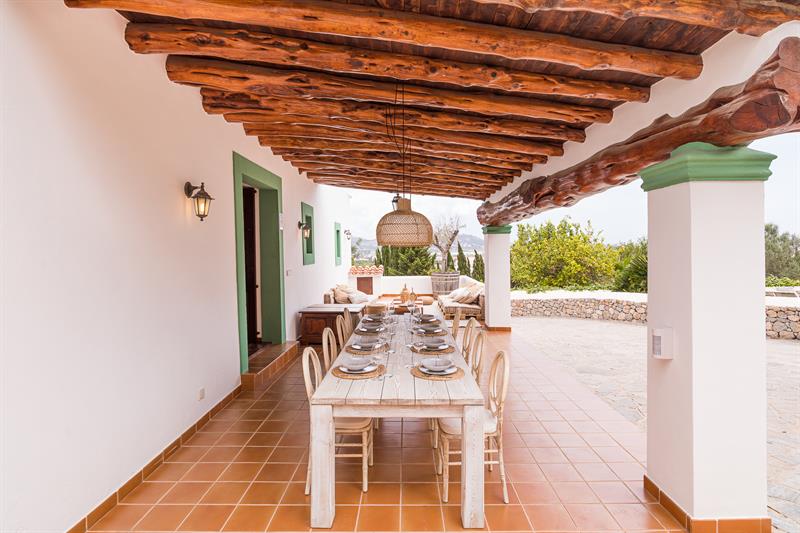 Long covered dining table on the terrace with views over the countryside